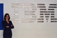 Picture of a woman posing in front of IBM's logo